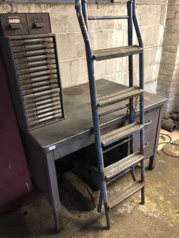 A steel desk, step ladder and filing drawers. (4)