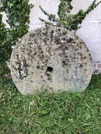 A stone grinding wheel, 90cm diameter.