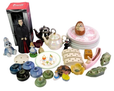 A group of Wade collectables, to include two anniversary teapots, a Dracula figure, Alice in Wonderland figure, plates, etc. (a quantity)