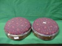 A pair of walnut framed circular foot stools with upholstered pads