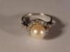 An 18ct white gold pearl and diamond ring