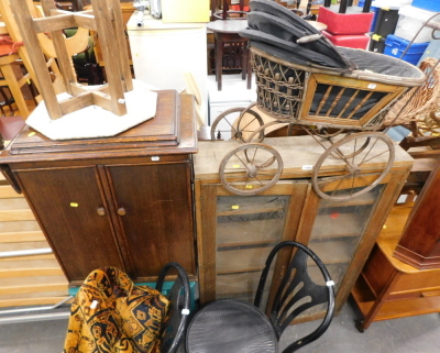 An oak two door cupboard, push pram, sewing machine table, side table, child's desk and chair, collapsible, two painted bentwood chairs, and rugs. (9) Buyer Note: VAT is payable on the hammer price of this lot