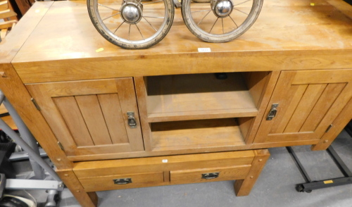 A beech effect TV stand, with two shelves and two cupboard doors, and an oak two drawer coffee table. (2)