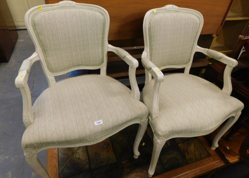 A pair of Louis XV style bedroom chairs, each cream painted with green and cream upholstered seats.