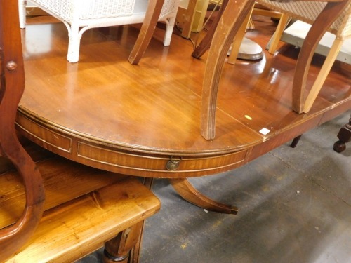 A mahogany extending dining table, the oval top raised on square tapering legs, 76cm high, the top 198cm x 112cm.