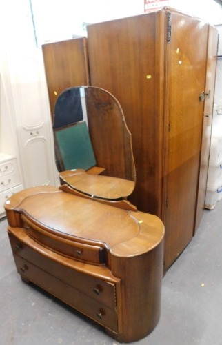 An oak bedroom suite, comprising two two door wardrobes, and a dressing table.