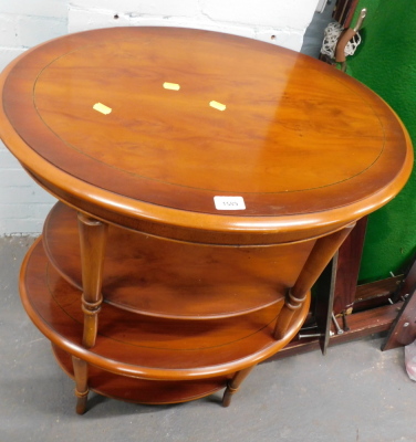 A pair of reproduction oval two tier side tables.