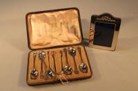 A set of six Edward VII silver coffee spoons with matching sugar tongs and a photograph frame