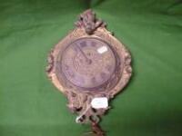 A gilt metal wall timepiece