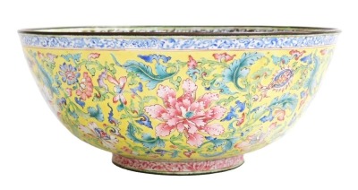 A fine 18thC Qianlong period Chinese polychrome enamel bowl, decorated in delicate famille rose colours with bats, peaches and a long life symbol to the interior; and with scrolling peonies on an Imperial yellow ground to the exterior, the base with phoe