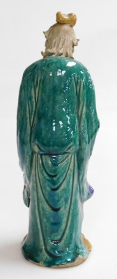 A 19th/20thC Chinese part glazed ceramic figure of a sage, in green, blue and yellow; holding a sheathed sword, 31cm high. - 3