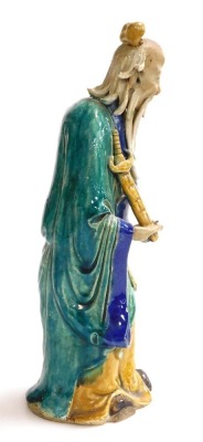 A 19th/20thC Chinese part glazed ceramic figure of a sage, in green, blue and yellow; holding a sheathed sword, 31cm high. - 4