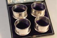 A set of four George V silver napkin rings by Walker & Hall