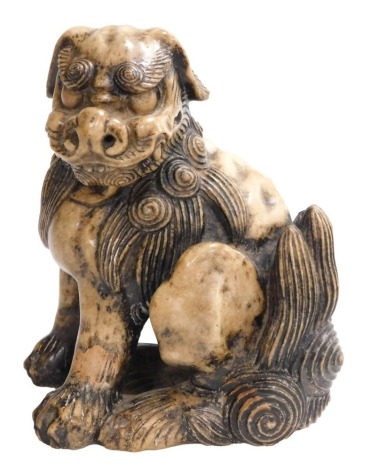 A fine Qing Dynasty Chinese soapstone figure of a seated Buddhist lion in powerful pose, the underside of the left leg with lengthy inscription, 19cm high. Provenance: The John and Margaret Rankine Collection. Accompanied with a copy of the purchase rece