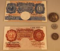 An English ten shilling note and a pound note together with coins