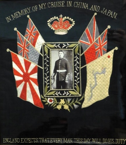 Early 20thC silk needlework panel with WW1 flags of the Allies. Black and white portrait photograph of a guardsman and inscribed "In the memory of my cruise in China and Japan, on black backing with England expects...in text to the lower border, 44cm x 39