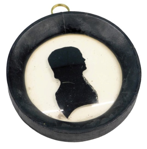 19thC. A verre eglomise silhouette portrait of a youth, 7cm diameter, ebonised frame.