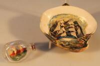 A miniature ship in a bottle and a shell diorama with a sailing ship