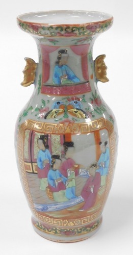 A 19thC Qing dynasty Chinese porcelain baluster vase, with a celadon glaze enriched in coloured enamels with figures at court, butterflies, flowers, etc., with moon shape lug handles, 24cm high. (AF)