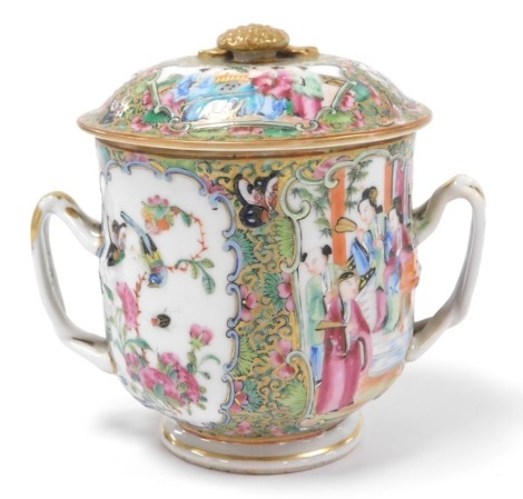 A 19thC Qing dynasty Chinese porcelain posset pot, decorated in famille rose Canton style enamels, with double loop handles and gilt knop, 13cm high, 16cm diameter over handles.