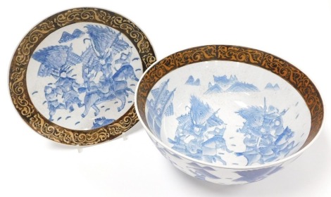 A 20thC Chinese porcelain bowl, decorated with fighting figures on horseback and swordsmen in blue and white having a dark brown border and Qianlong seal mark to base, together with a matching saucer dish, the bowl 17cm high, 36cm diameter, the dish 30cm 