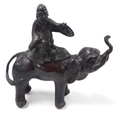 A 19thC Qing dynasty Chinese bronze incense burner, modelled as an elephant with seated sage forming the detachable cover, 20cm high.