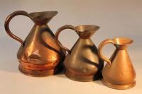 Three Victorian graduated copper jugs.