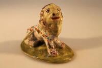 A late 19thC faience polychrome decorated lion