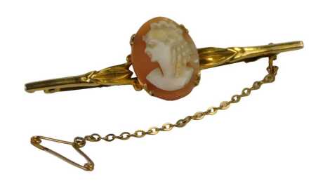 A shell cameo brooch, the cameo depicting a maiden, in a four claw setting, on a yellow metal bar with a safety chain, stamped 9ct, 6cm wide, 5.8g all in.