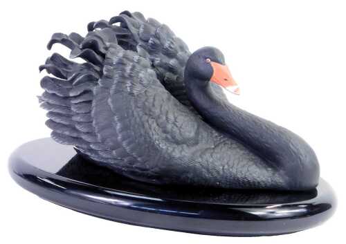 A Franklin Mint bisque porcelain figure modelled as The Black Australian Swan, on an ebonised base, 16cm high.