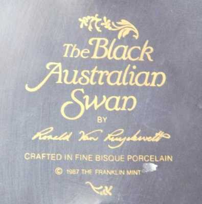 A Franklin Mint bisque porcelain figure modelled as The Black Australian Swan, on an ebonised base, 16cm high. - 2