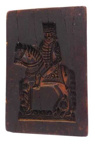 A wax biscuit mould, of rectangular form, carved with a figure on horseback, 31cm x 20cm.