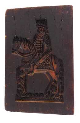 A wax biscuit mould, of rectangular form, carved with a figure on horseback, 31cm x 20cm.