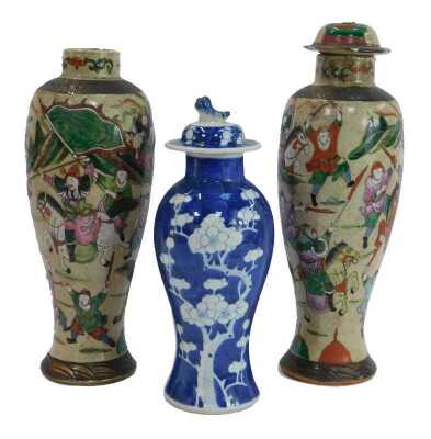 A Chinese jar and cover, decorated with blossoming prunus against a cracked ice ground, 27cm high, together with two Japanese Satsuma pottery vases of baluster form, decorated with figures on horseback, warriors, etc., one with lid, drilled, 31cm high. (A