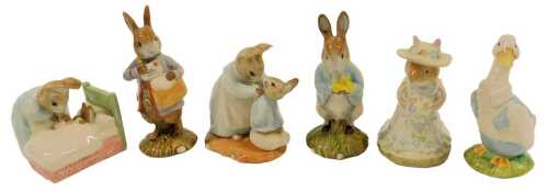 Six Beswick Beatrix Potter pottery figures, modelled as Peter in Bed, Peter with Postbag, Mr Drake Puddleduck, Poppy Eyebright, Peter with Daffodils, and Mrs Rabbit and Peter, four boxed.