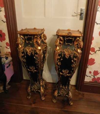 A pair of Continental ebonised urn tables, decorated with female figures, scrolls etc., gilt heightened, 82cm high. This lot is located offsite. For further details and to arrange a viewing, please call The Bourne Auction Rooms on 01778 422686.