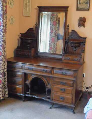 A Victorian walnut dressing table, with bevelled plate mirror, support panels with drawers and a fitted drawer base, 162cm high, 137cm wide, 62cm deep. This lot is located offsite. For further details and to arrange a viewing, please call The Bourne Aucti