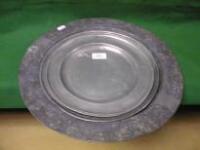 Two antique pewter plates with folded rims and a large pewter platter