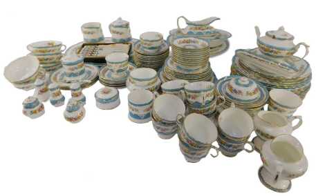 A Crown Staffordshire porcelain part tea and dinner service, decorated with flowers against a blue and white ground, to include teapot, milk jug, teacups and saucers, salt and pepper shakers, dinner plates, pedestal stand, etc. (3 trays and loose)