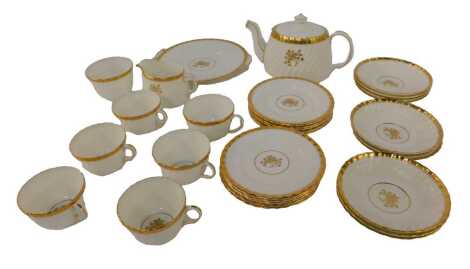 A Mintons porcelain Gold Rose pattern tea service, comprising a teapot, sugar bowl, milk jug, six teacups, ten saucers, ten cake plates, and a twin handled sandwich plate.