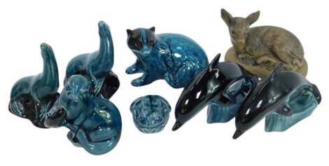 A group of Poole pottery figures, comprising two dolphins, 10cm high, a badger, two seals, one otter, and a toad, together with a matte porcelain Poole figure of a recumbent fawn, 10cm high.