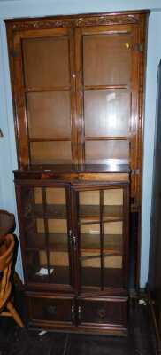 An oak bookcase, with two glazed doors enclosing an arrangement of shelves, together with an open bookcase, and another.