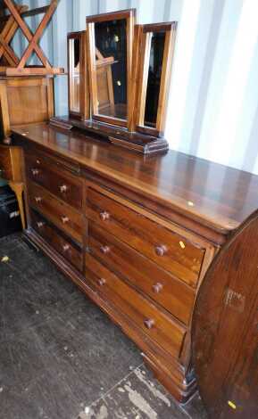 A 20thC cherry wood chest, the rectangular top with a rounded edge above two concealed drawers, the base with an arrangement of six drawers, on bracket feet, 90cm high, 151cm wide, 52.5cm deep, together with a similar three fold mirror.