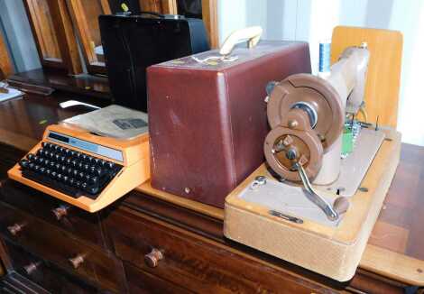 A Singer cased sewing machine, together with a Silver Read 100 typewriter.