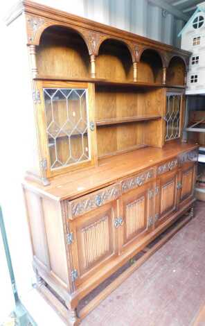 An Old Charm style oak sideboard, 136cm high, 189cm wide, 48cm deep.