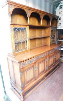 An Old Charm style oak sideboard, 136cm high, 189cm wide, 48cm deep.