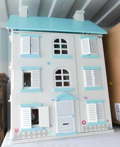 A contemporary three storey dolls house, in cream, 84cm high.