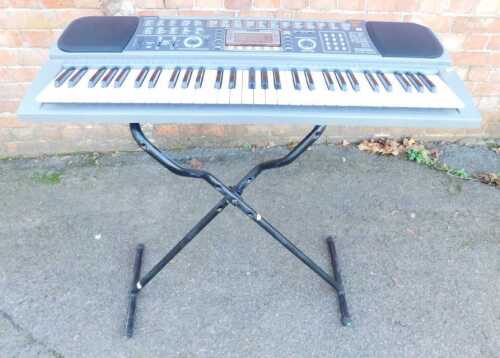 A Casio CTK-601 electric keyboard, with stand.