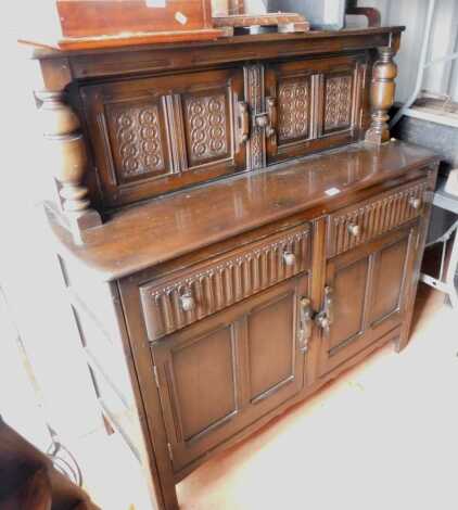 A 20thC oak court type cupboard, 140cm high, 125cm wide, 50cm deep.