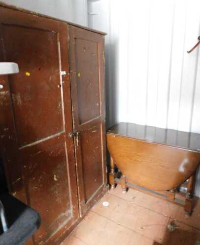 A painted pine cabinet, with two panelled doors, enclosing various shelves, 177cm high, 114cm wide, 43cm deep, together with an oak drop leaf table.